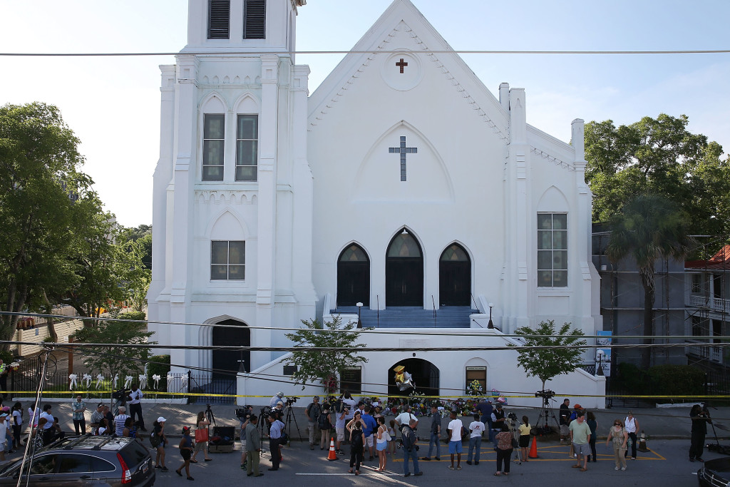 CHARLESTON, SC - JUNE 18: People stand outside the Emanuel AME Church after a mass shooting at the church that killed nine people on June 18, 2015, in Charleston, South Carolina. A 21-year-old suspect, Dylann Roof of Lexington, South Carolina, was arrersted Thursday during a traffic stop. Emanuel AME Church is one of the oldest in the South. (Photo by Joe Raedle/Getty Images)